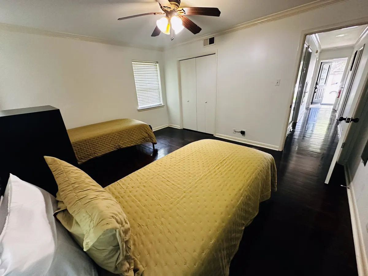 A shared bedroom with two single beds in an Austin sober living home