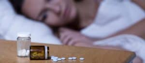 woman taking sleeping pills