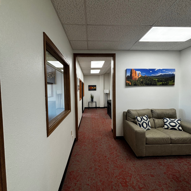 Hallway with art and natural light leading to therapy offices