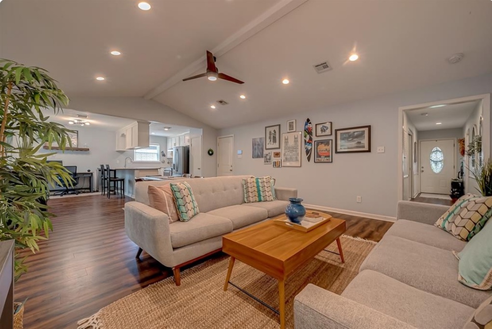 Open-concept living room and kitchen inside Houston women’s sober living home.