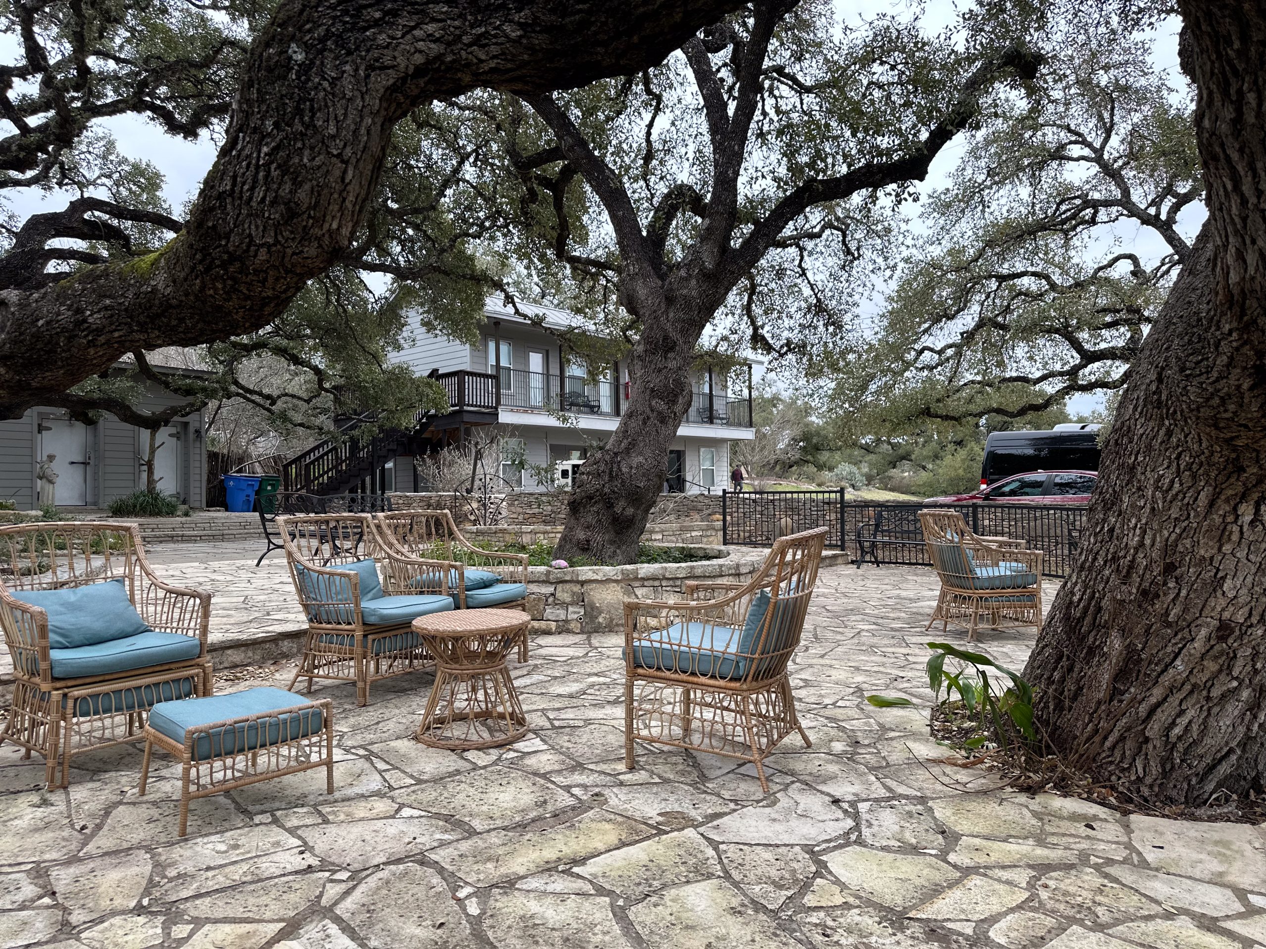 Outdoor meeting circle with benches and flagstone paths on Nova Recovery Center’s Wimberley campus.