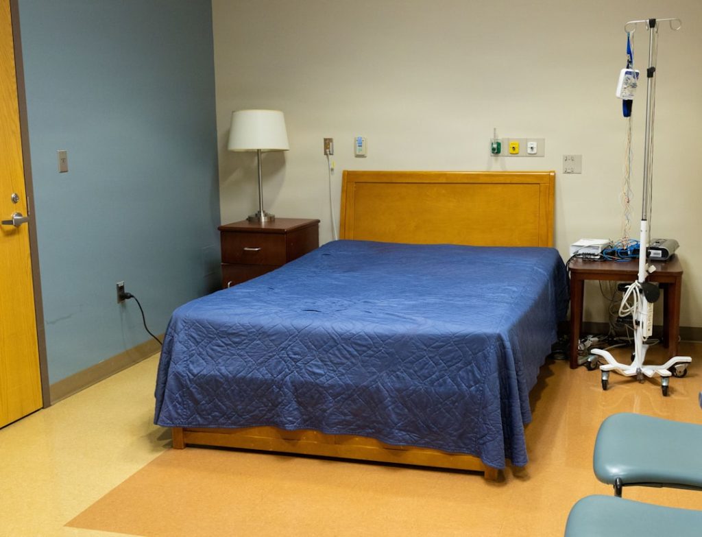 A hospital room with a bed and iv pole. -- Photo by Navy Medicine on Unsplash