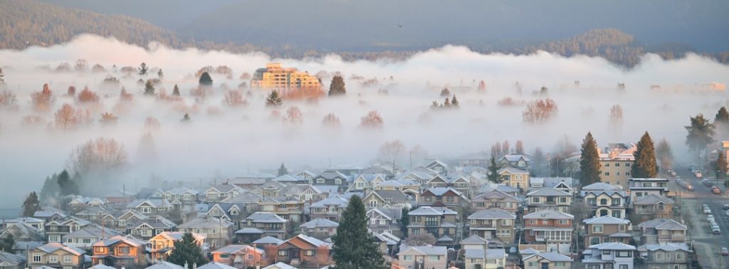 Town covered in snow and fog at sunrise. -- Photo by Jonathan Lim on Unsplash