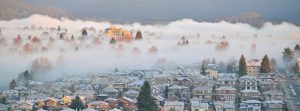 Town covered in snow and fog at sunrise. -- Photo by Jonathan Lim on Unsplash