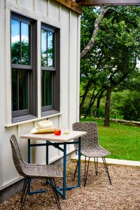 black metal table and chairs near green tree during daytime -- Photo by Megan Bucknall on Unsplash