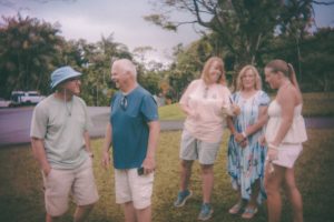 A group of five people standing on grass -- Photo by Devin Avery on Unsplash