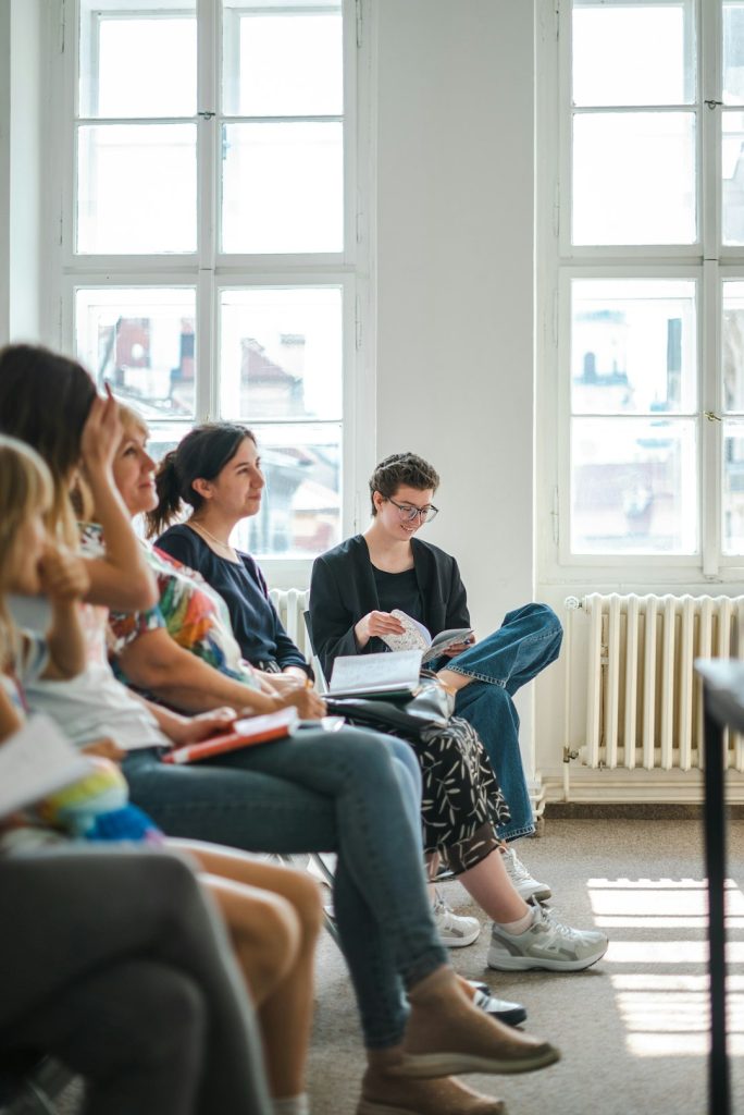 a group of people sitting in a room -- Photo by Timur Shakerzianov on Unsplash