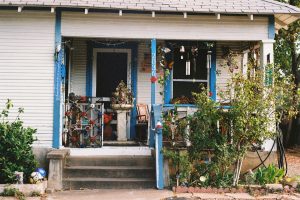 A charming house porch with blue trim and decorations. -- Photo by Sasha Matveeva on Unsplash