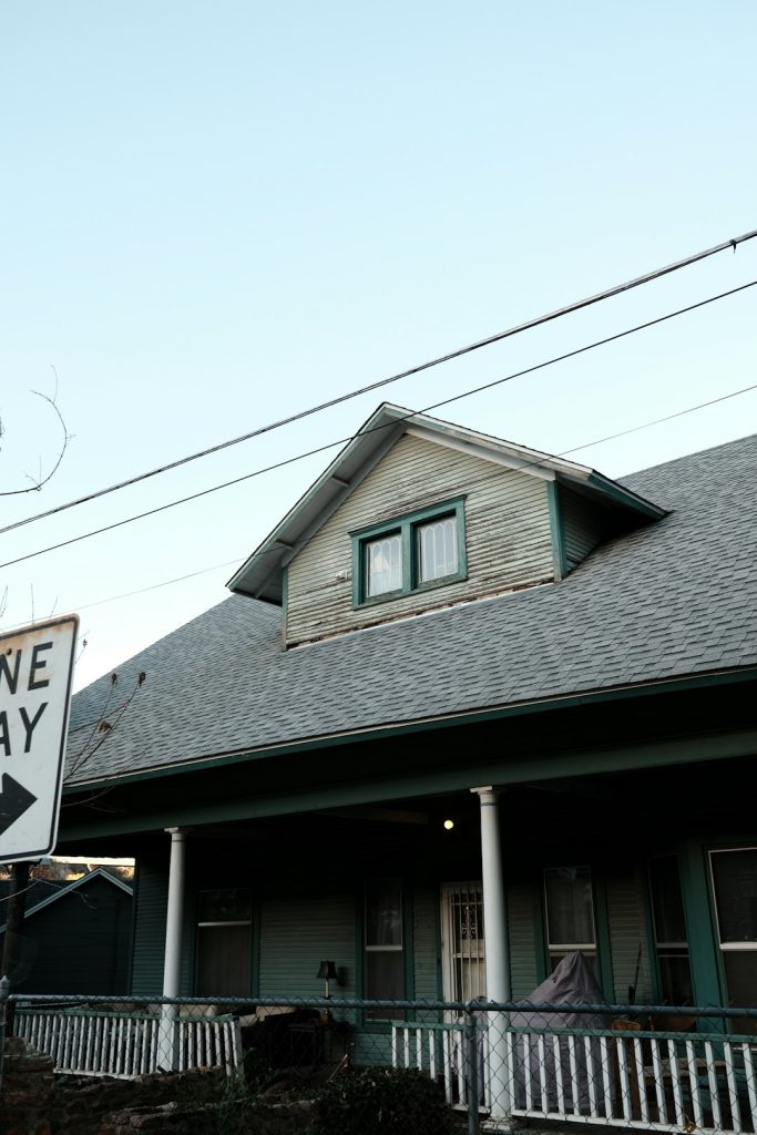 a one way sign in front of a house -- Photo by Julia Rodriguez on Unsplash